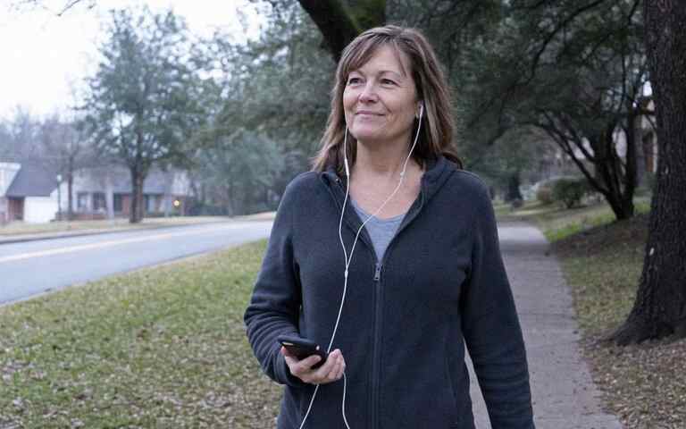 A woman listening during a quiet morning walk